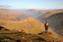06-2214 Hill walker enjoying the view north over Brothers Water from Red Screes, Lake District, Cumbria
